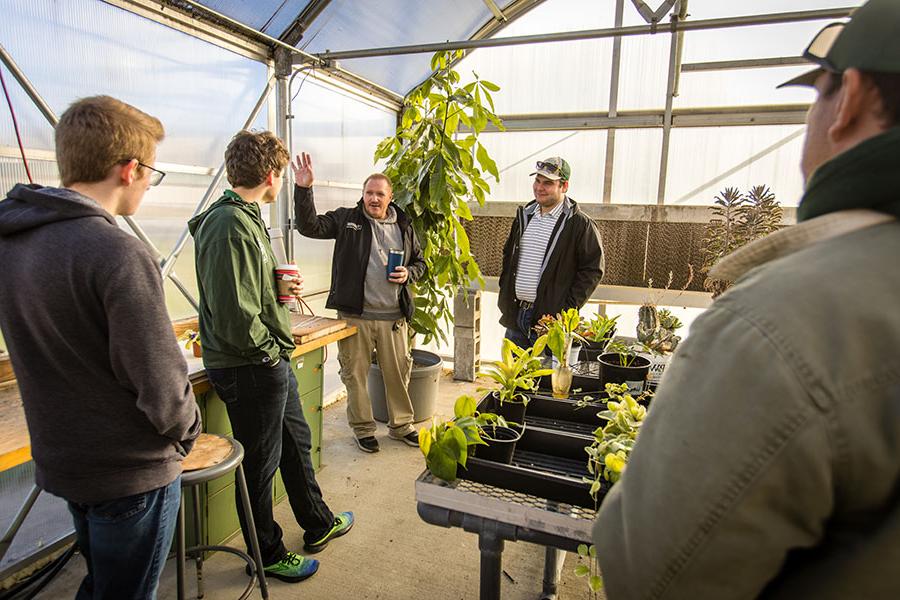 Students in Northwest's Internet of Things course talk with Bryan Freemyer, an arboretum specialist at the University, about the sensor platform they set up inside the Horticulture Complex to better monitor plant life there. (Photos by Lauren Adams/Northwest Missouri State University)